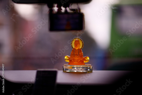 Buddha statue inside car for protection. Bodhisattva Avalokitehvara. Quan Am or Guanyin. . Ho Chi Minh city. Vietnam. photo