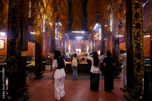 Canton Assembly Hall of Can Tho. Buddhist believers praying with incense sticks. Can Tho. Vietnam.