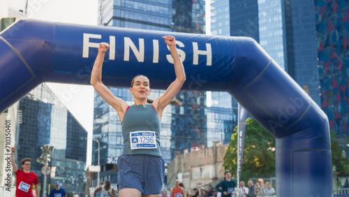 Portrait of a Happy Female City Marathon Runner Crossing the Finish Line and Celebrating her Victory. Female Race Winner Achieving her Goal and Enjoys her Accomplishement  