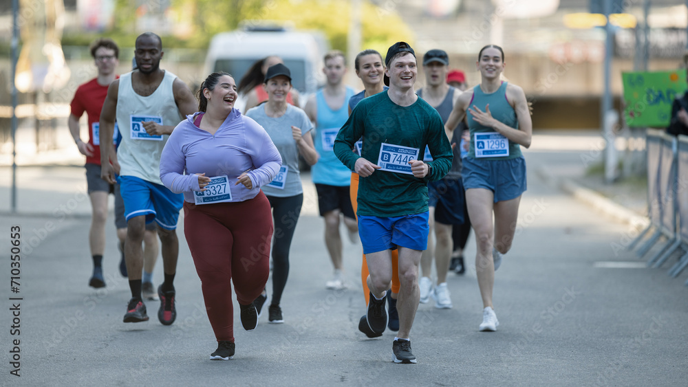 Group of Diverse People Running in a Marathon with the Cheers of their Loved Ones and Supporters in the Audience. Runners Participating in a Charity Run to Raise Money a Cause