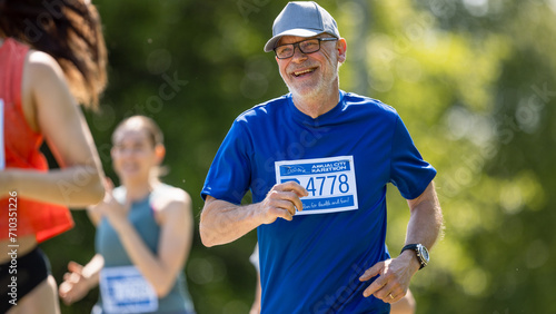 Portrait of a Senior Male Jogger Running in a Park on a Health Trail. Healthy and Fit Elderly Man Enjoying Physical Activity and Staying in Shape