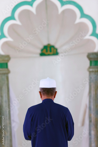 Jamiul Azhar mosque.  The friday prayer (salat). Muslim man praying in mosque. Vietnam. photo