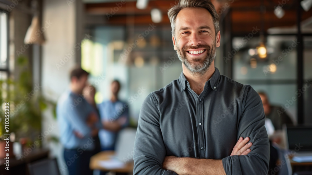 Portrait of a handsome smiling businessman boss standing in his modern business company office. Portrait of a handsome smiling businessman boss standing in his modern business company office.