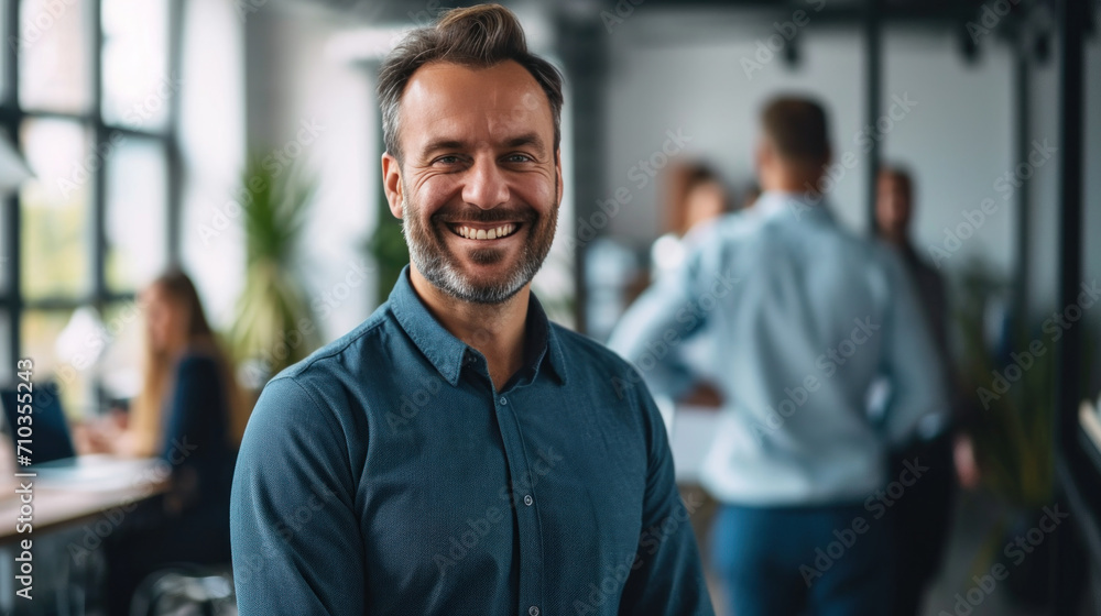 Portrait of a handsome smiling businessman boss standing in his modern business company office. Portrait of a handsome smiling businessman boss standing in his modern business company office.