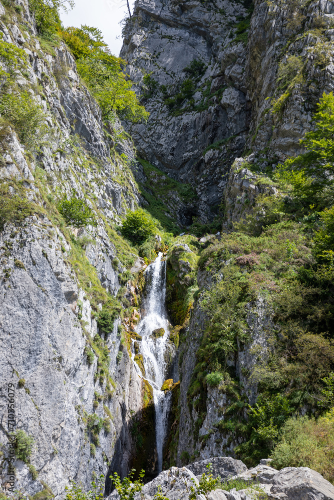 waterfall river comes down from the mountain in Lescun Pyrenees in France Europe