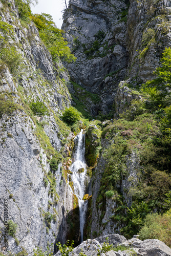 waterfall river comes down from the mountain in Lescun Pyrenees in France Europe