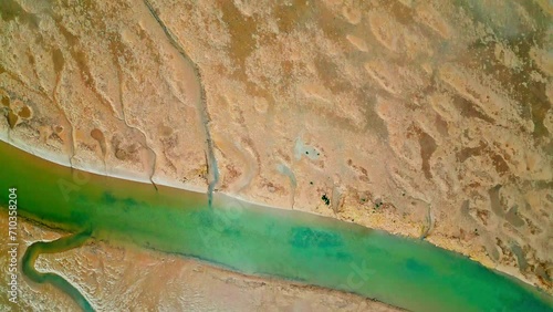 Cracked mud flats in a salt marsh. Aerial: Tidal mudflats, Abstract textures in a cracked coastline, Salt marshes at low tide exposing mud flats and streams at Freiston Shore Lincolnshire UK photo