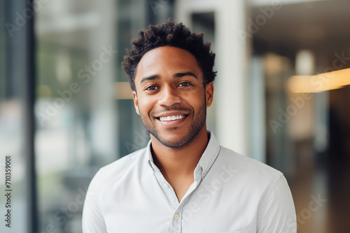 A happy professional black man, light blurry background  photo