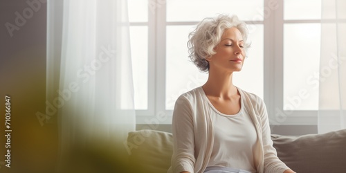 Middle aged woman meditating at home