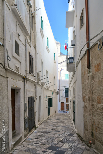A narrow street among the old houses of Monopoli  a town in the province of Bari  Italy.