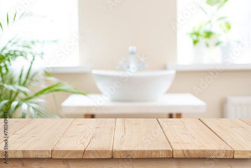 Blurred bathroom sink background and counter table top of wooden planks for products display montage photo