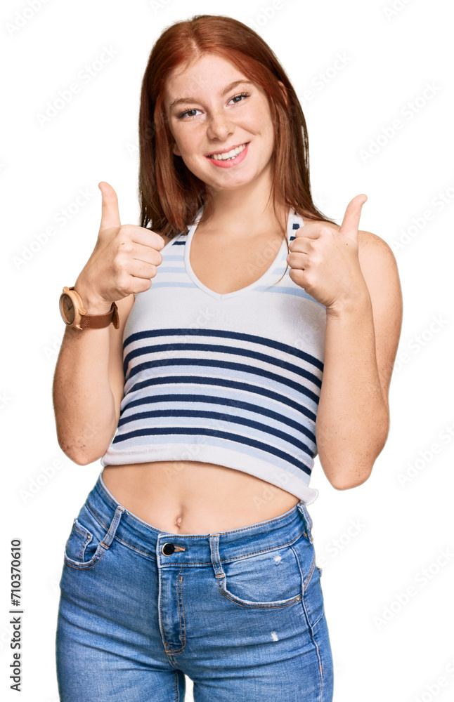 Young read head woman wearing casual clothes success sign doing positive gesture with hand, thumbs up smiling and happy. cheerful expression and winner gesture. Young read head woman wearing casual clothes success sign doing positive gesture with hand, thumbs up smiling and happy. cheerful expression and winner gesture.