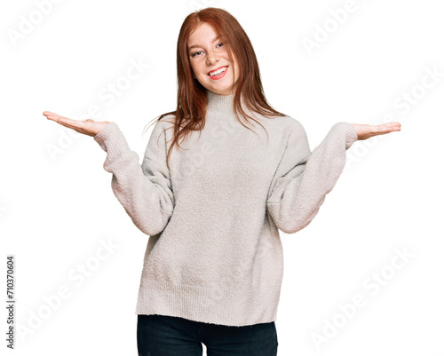 Young read head woman wearing casual winter sweater celebrating victory with happy smile and winner expression with raised hands