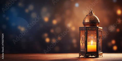 Hand holding a lantern on blurred background. Ramadan Kareem concept. photo