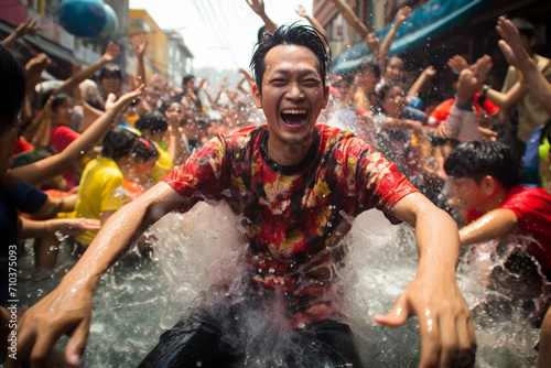 thai man playing water in songkran festival bokeh style background