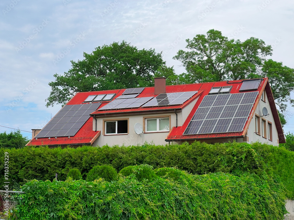 A Photo of a Modern Home with Solar Panels and Autumn Trees. A Showcase of Sustainable Living. A Sustainable and Eco-friendly Home Design.