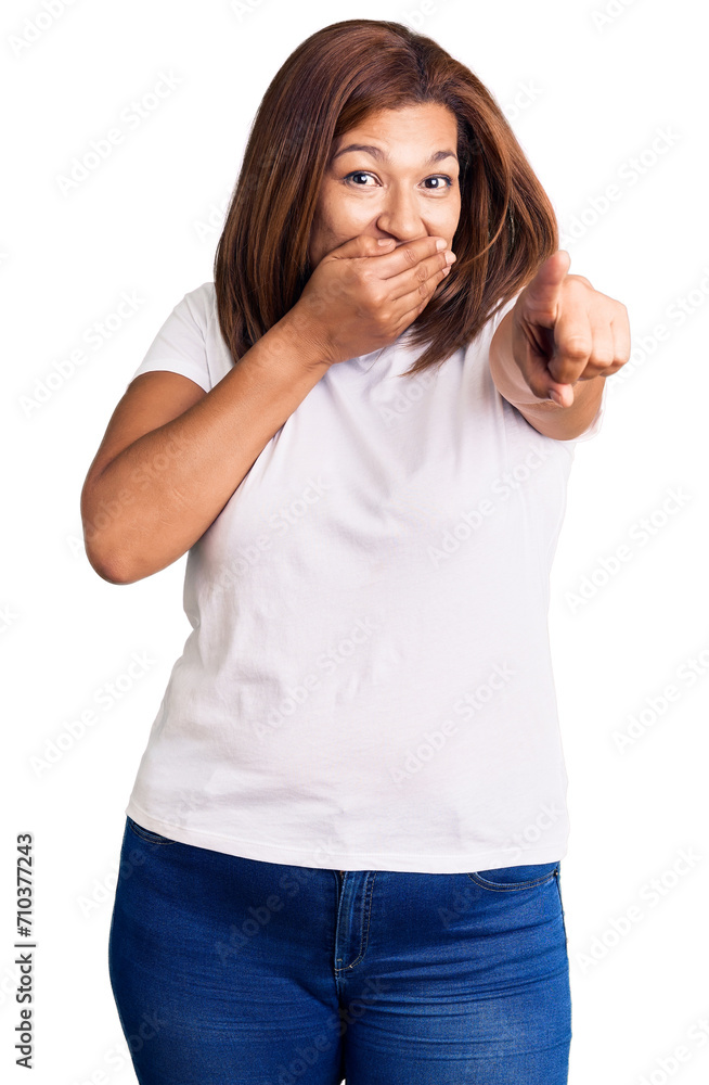 Middle age latin woman wearing casual white tshirt laughing at you, pointing finger to the camera with hand over mouth, shame expression Middle age latin woman wearing casual white tshirt laughing at you, pointing finger to the camera with hand over mouth, shame expression