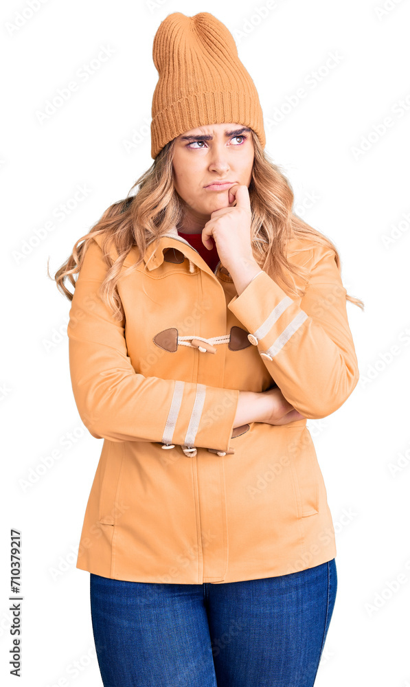 Young caucasian woman wearing casual clothes serious face thinking about question with hand on chin, thoughtful about confusing idea Young caucasian woman wearing casual clothes serious face thinking about question with hand on chin, thoughtful about confusing idea