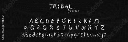 Tribal typeface in trendy y2k style. Hand drawn fire flame alphabet font. Vector grunge scrawl illustration.