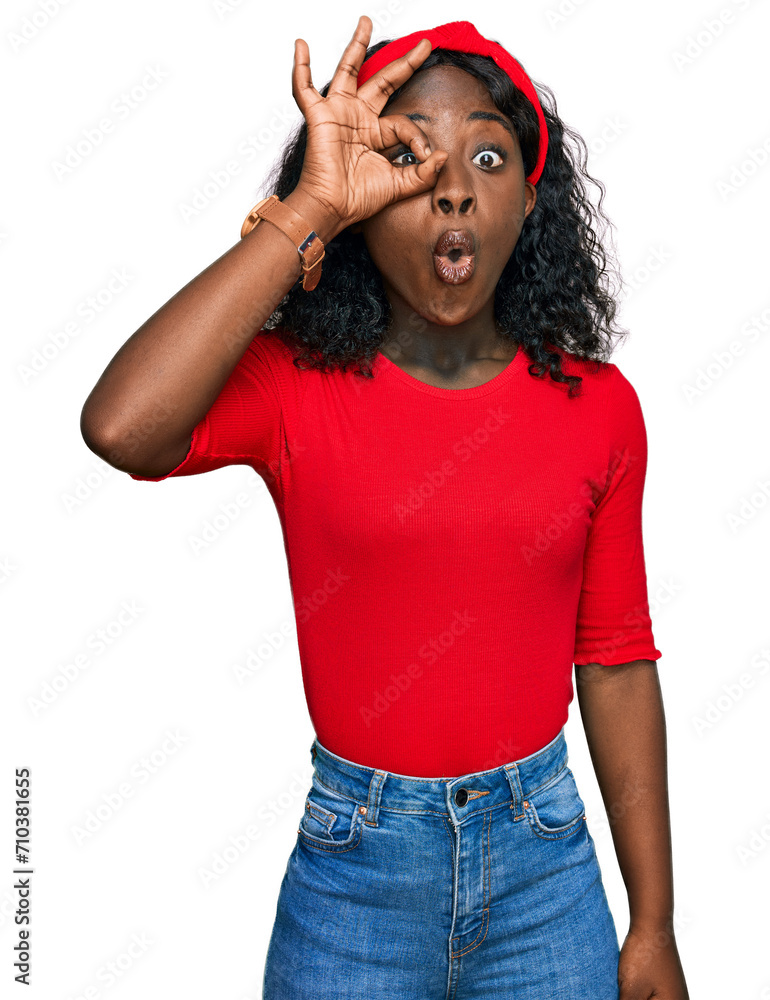 Beautiful african young woman wearing casual clothes doing ok gesture shocked with surprised face, eye looking through fingers. unbelieving expression. Beautiful african young woman wearing casual clothes doing ok gesture shocked with surprised face, eye looking through fingers. unbelieving expression.
