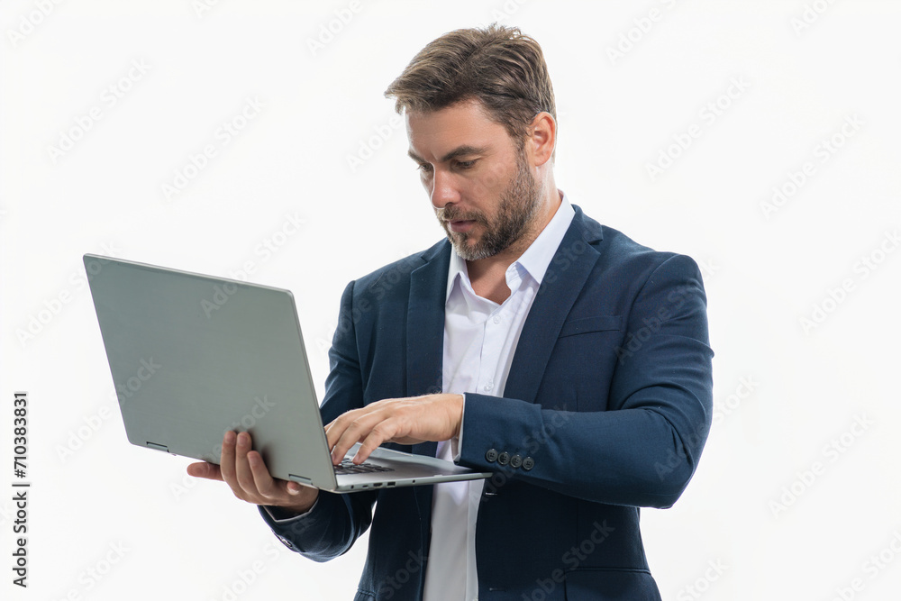 Millennial man in suit working on laptop in studio. Hispanic man checking information on laptop, typing information on laptop. Middle aged man searching information on laptops. Millennial man in suit working on laptop in studio. Hispanic man checking information on laptop, typing information on laptop. Middle aged man searching information on laptops.