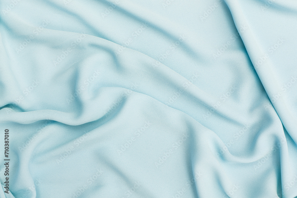 Obraz premium Closeup waving blue fabric background, blank blue fabric texture background