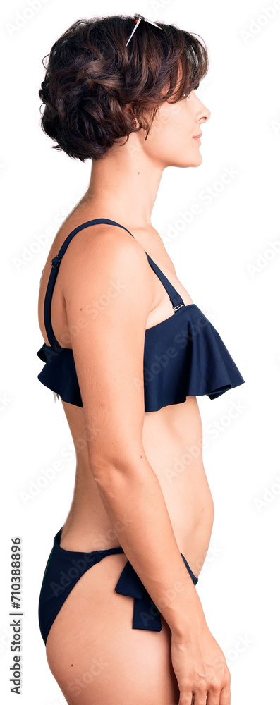 Beautiful young woman with short hair wearing bikini looking to side, relax profile pose with natural face with confident smile. Beautiful young woman with short hair wearing bikini looking to side, relax profile pose with natural face with confident smile.