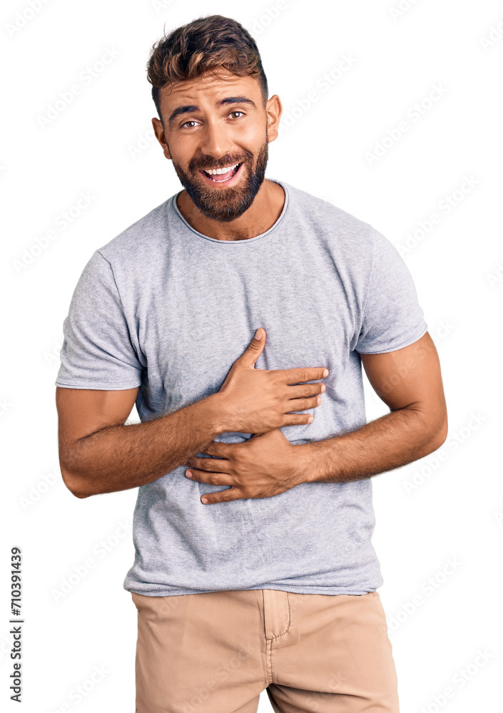 Young hispanic man wearing casual clothes smiling and laughing hard out loud because funny crazy joke with hands on body. Young hispanic man wearing casual clothes smiling and laughing hard out loud because funny crazy joke with hands on body.