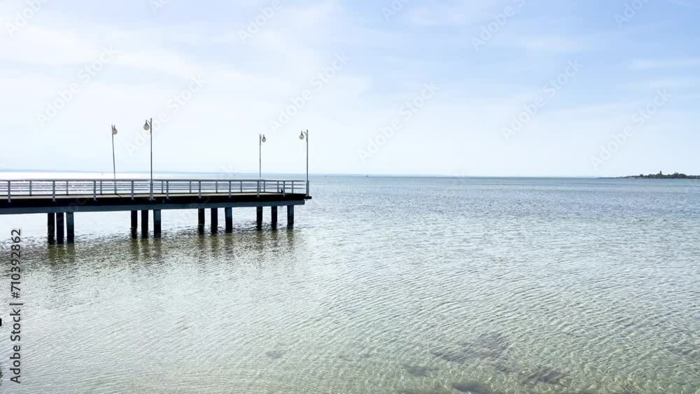A peaceful wooden dock over calm waters - Jurata, Poland A peaceful wooden dock over calm waters - Jurata, Poland