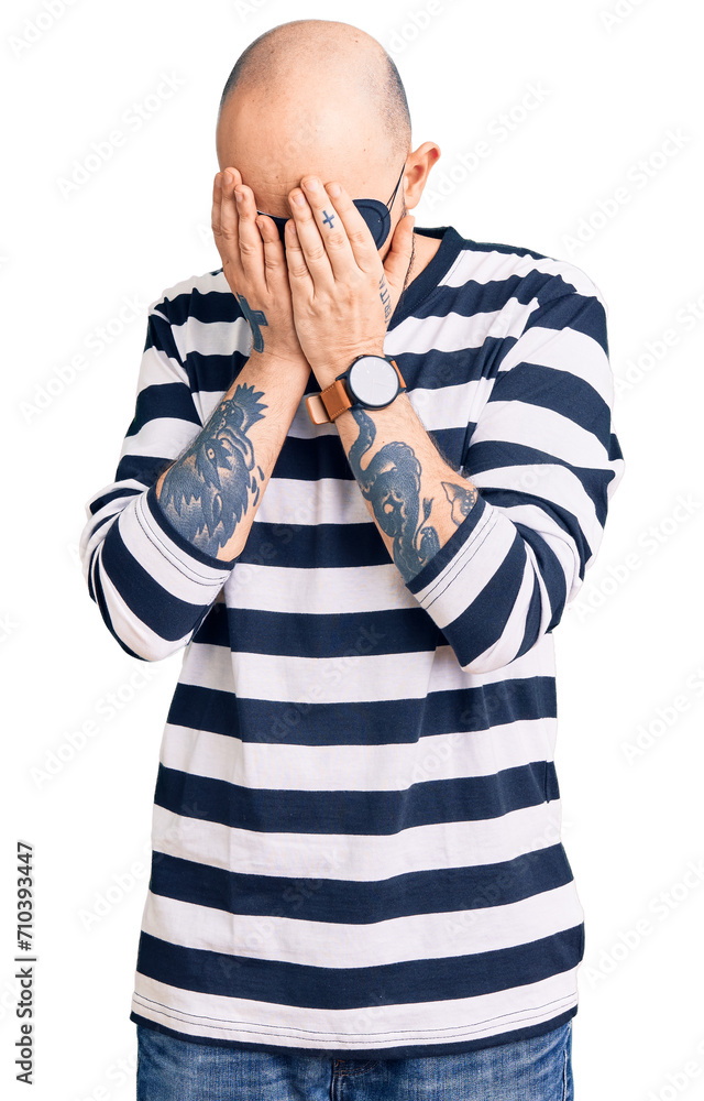 Young handsome man wearing burglar mask with sad expression covering face with hands while crying. depression concept. Young handsome man wearing burglar mask with sad expression covering face with hands while crying. depression concept.