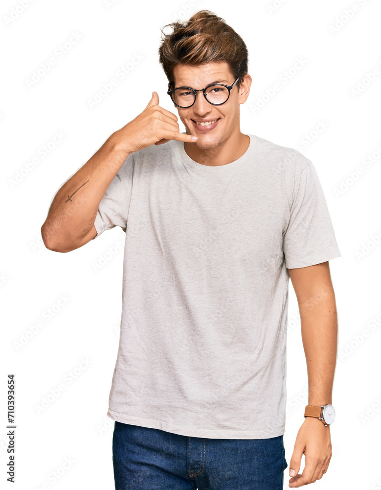 Handsome caucasian man wearing casual clothes and glasses smiling doing phone gesture with hand and fingers like talking on the telephone. communicating concepts. Handsome caucasian man wearing casual clothes and glasses smiling doing phone gesture with hand and fingers like talking on the telephone. communicating concepts.