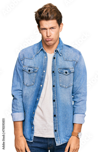 Handsome caucasian man wearing casual denim jacket depressed and worry for distress, crying angry and afraid. sad expression.