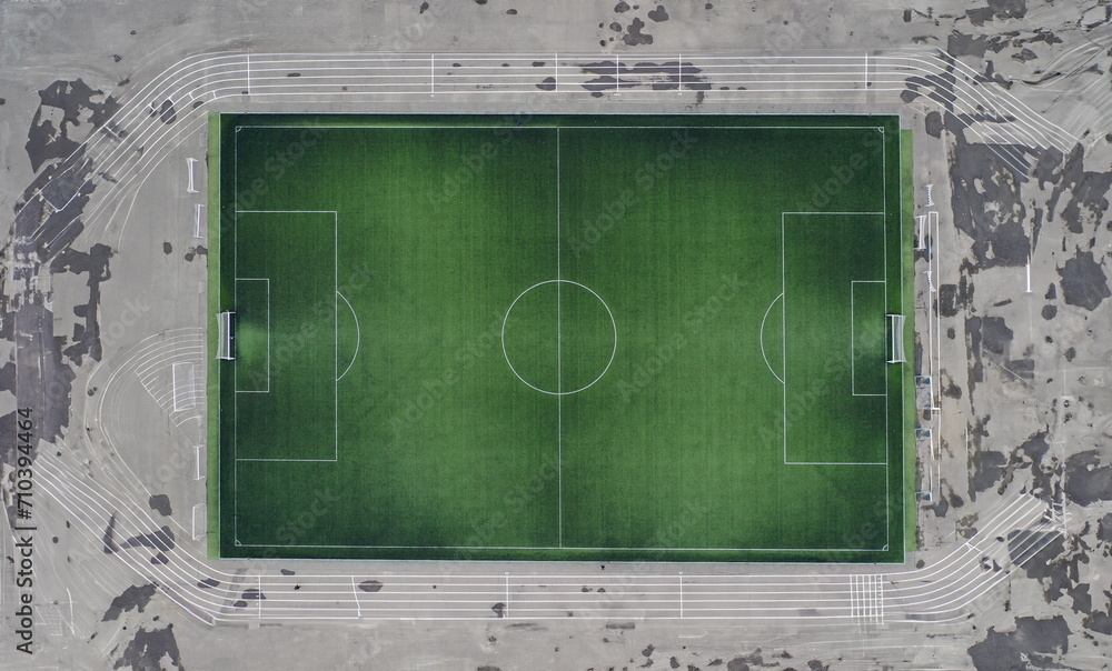 Fototapeta premium Large green football field at stadium. Construction of football arenas and stadiums concept