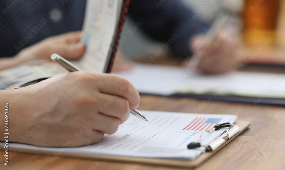 Man filling out documents for US visa closeup. Official travel abroad concept Man filling out documents for US visa closeup. Official travel abroad concept