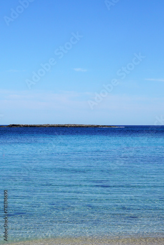 Natural landscape of Playa de Cavalleria  Mercadal  in Minorca beach with clear blue sky and rocky seashore- Menorca  Spain