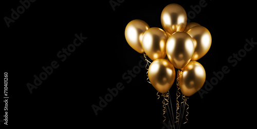 Holidays, birthday party, wedding decoration concept, golden metallic helium balloons on black background. Gold balloons for background, celebrating, greeting card