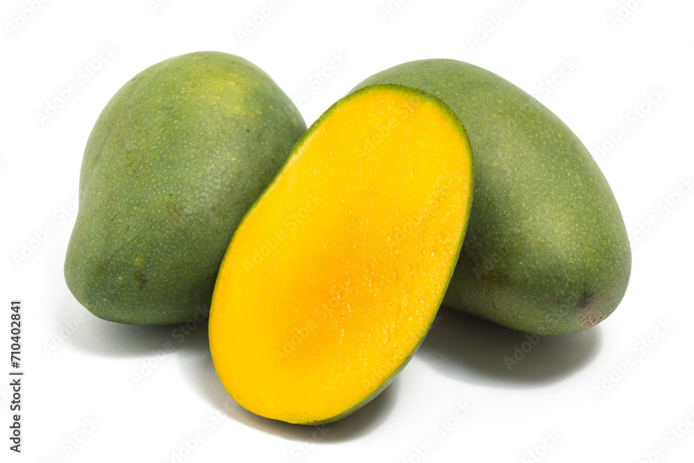 Half cut and two whole fresh organic green mango delicious fruit side view isolated on white background clipping path Half cut and two whole fresh organic green mango delicious fruit side view isolated on white background clipping path