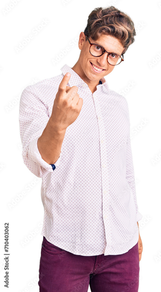 Young handsome man wearing business clothes and glasses beckoning come here gesture with hand inviting welcoming happy and smiling Young handsome man wearing business clothes and glasses beckoning come here gesture with hand inviting welcoming happy and smiling