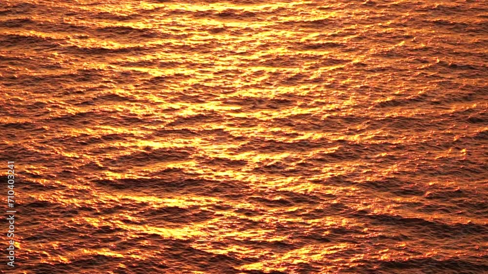 Sea water surface. Aerial view on golden sea water at sunset. Sun glare. Abstract nautical summer ocean nature. Holiday, vacation and travel concept. Nobody. Slow motion. Weather and climate change Sea water surface. Aerial view on golden sea water at sunset. Sun glare. Abstract nautical summer ocean nature. Holiday, vacation and travel concept. Nobody. Slow motion. Weather and climate change