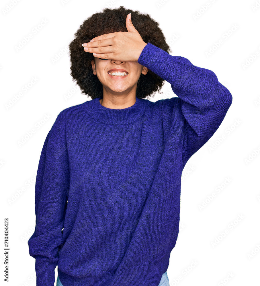 Young hispanic girl wearing casual winter sweater and glasses smiling and laughing with hand on face covering eyes for surprise. blind concept. Young hispanic girl wearing casual winter sweater and glasses smiling and laughing with hand on face covering eyes for surprise. blind concept.