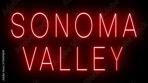 Flickering red retro style neon sign glowing against a black background for SONOMA VALLEY