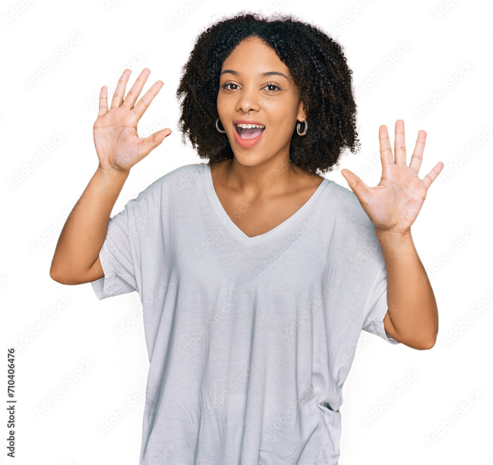 Young african american girl wearing casual clothes showing and pointing up with fingers number ten while smiling confident and happy. Young african american girl wearing casual clothes showing and pointing up with fingers number ten while smiling confident and happy.