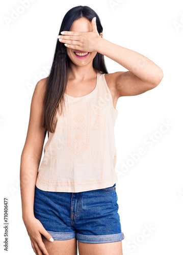 Young beautiful caucasian woman wearing casual clothes and glasses smiling and laughing with hand on face covering eyes for surprise. blind concept. © Krakenimages.com