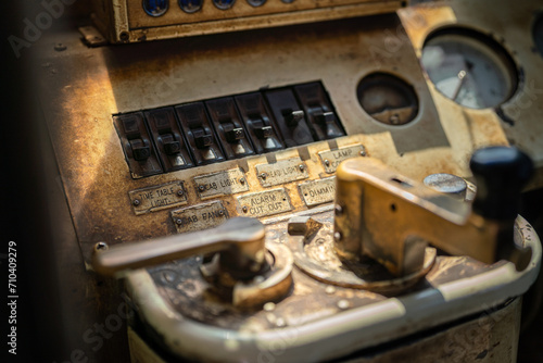 Close-up at analog switches to operate the electric device in the train cabin, that located on control panel of train driving cockpit. Transporation equipment and vehicle part object photo. 