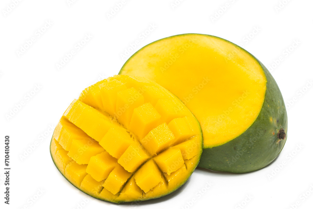 Cut into cubes and sliced half cut fresh organic green mango delicious fruit side view isolated on white background clipping path