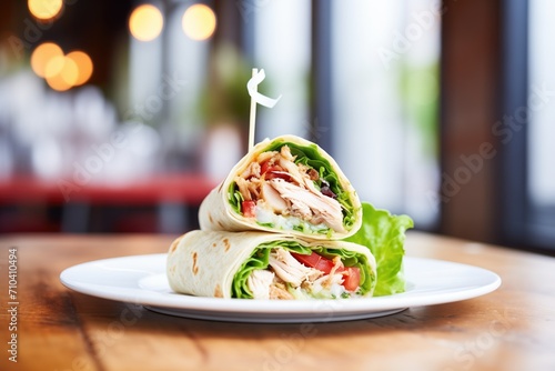 grilled chicken in a wrap with lettuce and tomatoes