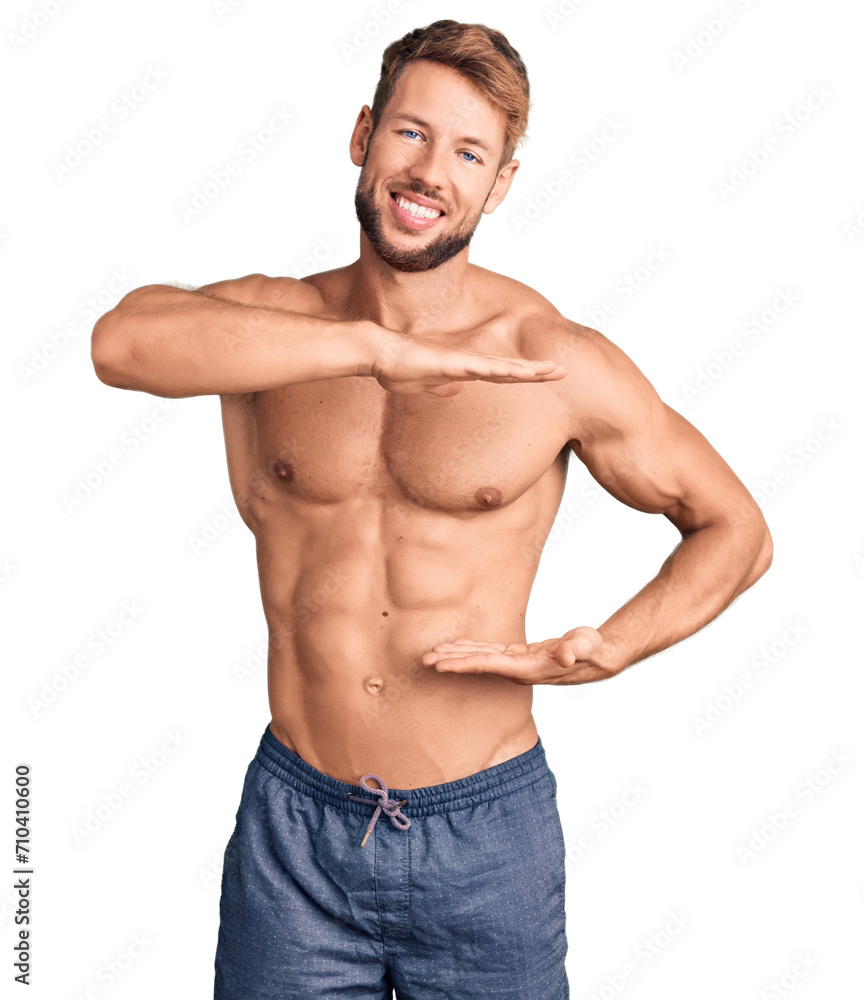 Young caucasian man standing shirtless gesturing with hands showing big and large size sign, measure symbol. smiling looking at the camera. measuring concept. Young caucasian man standing shirtless gesturing with hands showing big and large size sign, measure symbol. smiling looking at the camera. measuring concept.