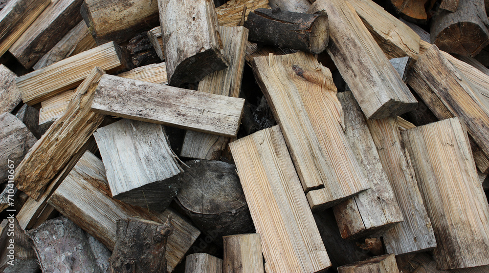 A pile of aged oak firewood chopped for heating in the stove
A pile of aged oak firewood chopped for heating in the stove