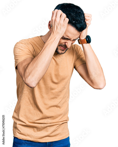 Canvastavla Hispanic man with beard wearing casual t shirt suffering from headache desperate and stressed because pain and migraine