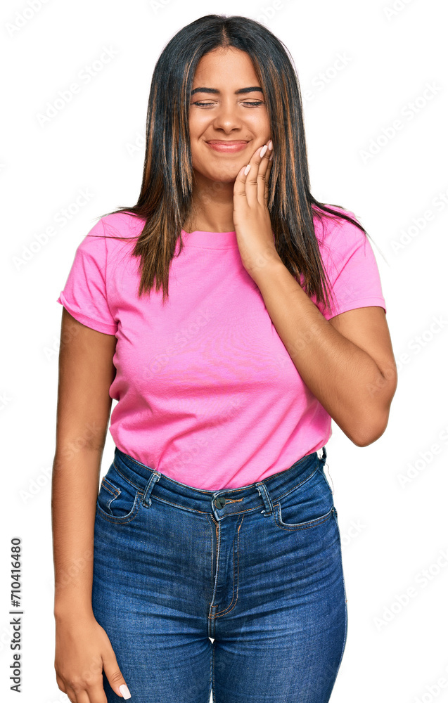 Young latin girl wearing casual clothes touching mouth with hand with painful expression because of toothache or dental illness on teeth. dentist Young latin girl wearing casual clothes touching mouth with hand with painful expression because of toothache or dental illness on teeth. dentist